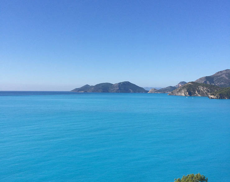 View of the blue sea with a few pieces of land in the background